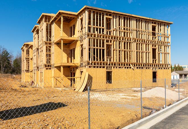 a close-up of temporary chain link fences enclosing a job site, signaling progress in the project's development in Charlotte Hall